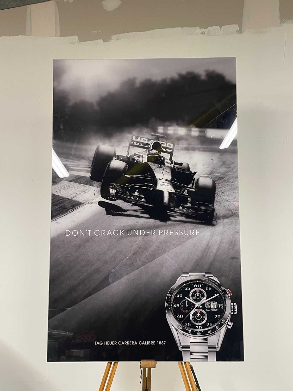 Lot A Perspex picture of a McLaren F1 car and watch for a TAG HEUER advertisement