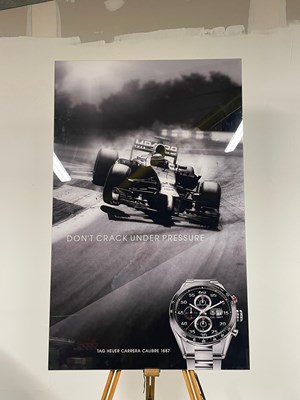 Lot A Perspex picture of a McLaren F1 car and watch for a TAG HEUER advertisement