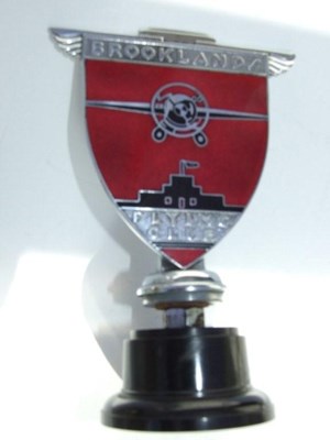 Lot 111 - a chromed brass with red and black enamel inter-war period Brooklands Flying Badge