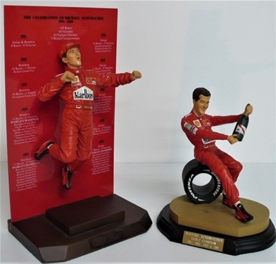 Lot 25 - Two 1/8 scale resin motor racing driver figures, both show seven times Formula 1 World Champion Michael Schumacher in celebratory mode.