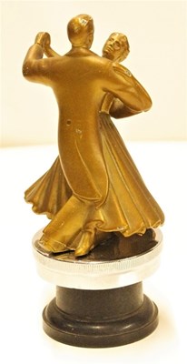 Lot 33 - A Fred Astaire and Ginger Rogers dancing couple motor mascot, both dressed in full evening dress. Fitted to a display base.