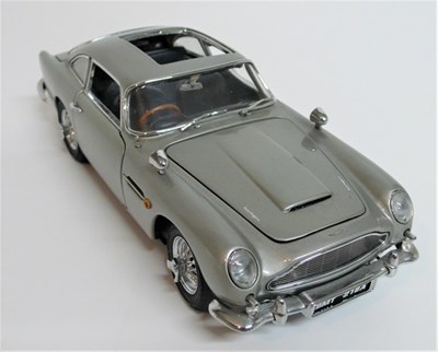 Lot 57 - A Danbury Mint die-cast model of the 1964 Aston Martin DB5 finished in metallic red with tan interior. This model has opening bonnet, doors and boot with full interior, engine and drive train detail