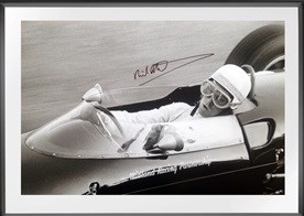 Lot 53 - A framed and glazed close-up cockpit shot of Richard Attwood at speed in the Lola Mk. V A-Ford.