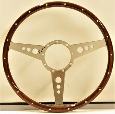 Lot 79 - A signed Stirling Moss commemorative wood rimmed steering wheel