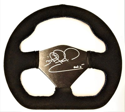 Lot 80 - A presentation steering wheel in the form of an F1 car’s wheel, signed by Nigel Mansell.