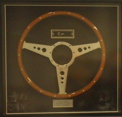 Lot 81 - A wood rimmed steering wheel signed by Stirling Moss & Tony Brooks