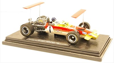 Lot 100 - A 1/18 scale model showing Graham Hill sitting in the 1969 Gold Leaf Ford powered Lotus 49.