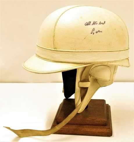 Lot 119 - An early peaked Everoak Corker crash helmet signed by Stirling Moss with “All the best” dedication by Moss