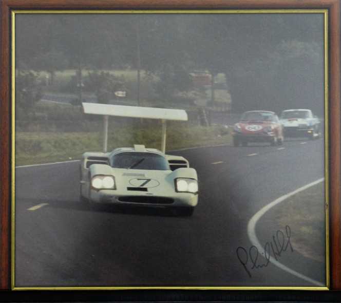 Click for high resolution Lot 23 - A framed and glazed print showing Phil Hill