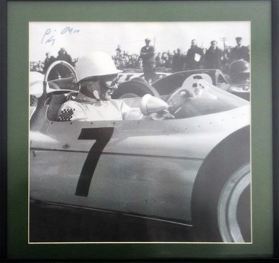 Lot 52 - A framed and glazed print showing Stirling Moss on the grid waiting for the off