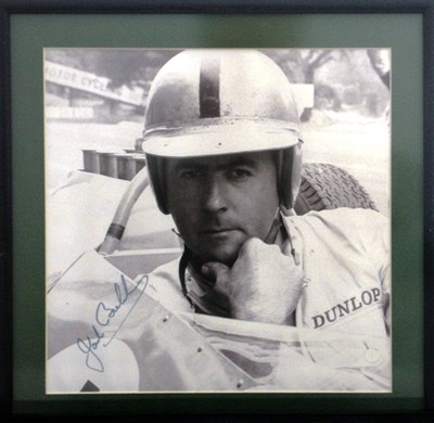 Lot 54 - A framed and glazed print showing Jack Brabham