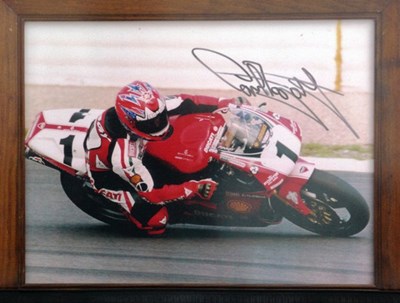 Lot 57 - A framed and glazed print showing Carl Fogarty